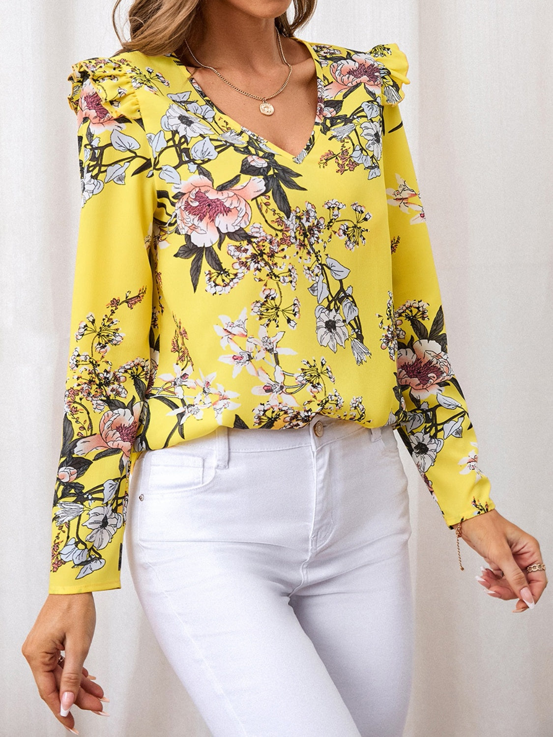 Floral ruffle blouse in yellow with a V-neckline, perfect for both casual and dressy outfits.
