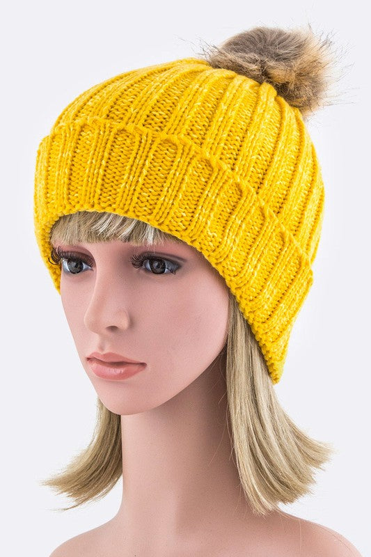 Cheerful yellow ribbed knit winter hat with a stylish faux fur pom.
