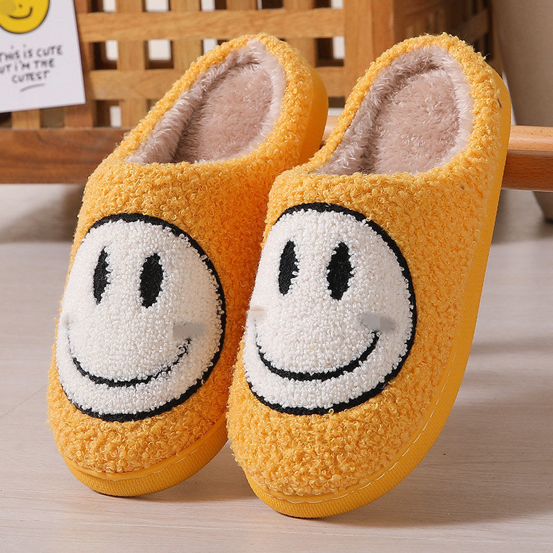 Yellow smiley face cotton slippers with a plush design for comfort
